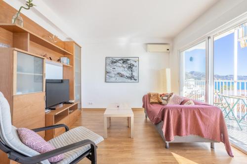 a living room with a couch and a tv at Sirena in Nerja