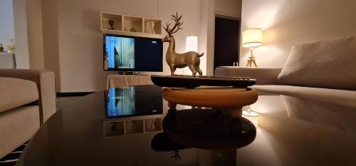 a living room with a couch and a table with a tv at راحة Comfort in Riyadh
