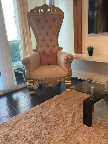 a living room with a chair and a glass table at Dream Village Boca Chica frente a la playa in Boca Chica