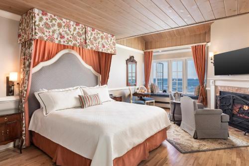 a bedroom with a bed and a living room at Spindrift Inn in Monterey