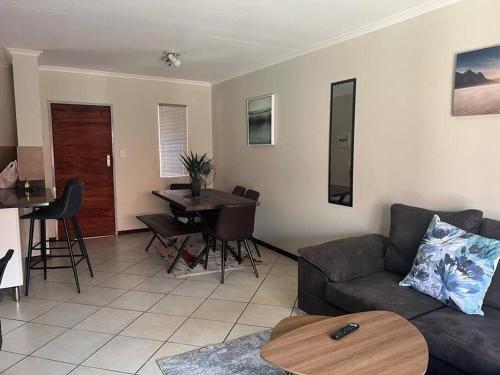 een woonkamer met een bank en een tafel bij Centurion: Chilled Townhouse in Centurion