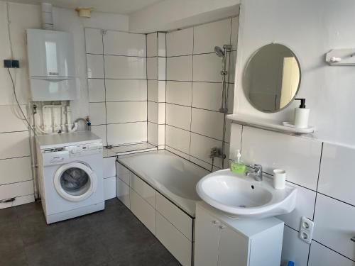 a bathroom with a washing machine and a sink at Apartment for rent 1 in Celle