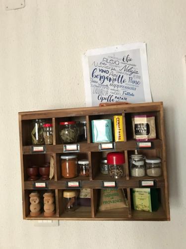 a wooden shelf with various items on a wall at Casa Marida in Camigliatello Silano