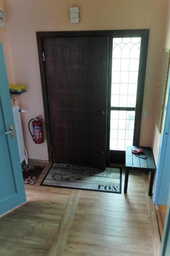 a black door in a room with a wooden floor at Ferienhaus mit Kamin in Småland für 6 Personen in Järnforsen