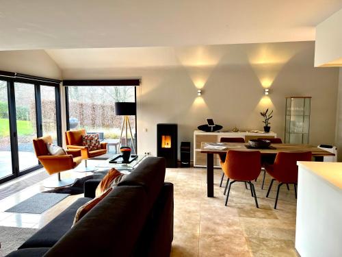 a living room with a couch and a table at Sakura Lodging in Bossut-Gottechain