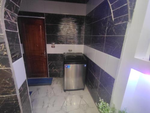 a small bathroom with a trash can in the corner at The nubian white house in Aswan