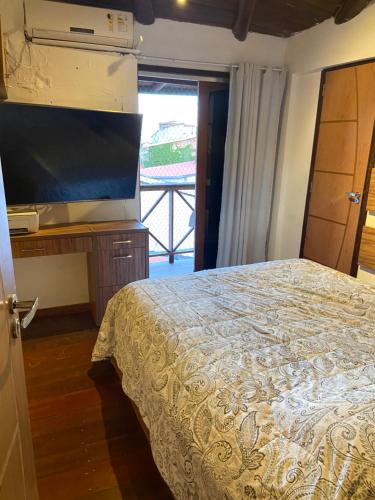 Ένα ή περισσότερα κρεβάτια σε δωμάτιο στο Casa dos Ventos Morro de SP