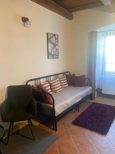 a couch and a chair in a living room at Vila Lucia - Apartmán 1 in Plzeň