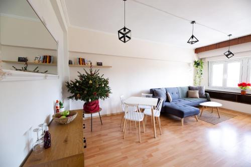 a living room with a blue couch and a table at Venus in Thessaloniki