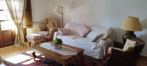 a living room with a couch and a table at OROEL Beds & Dreams - Espectacular planta baja en Badaguás-Pirineo in Badaguás
