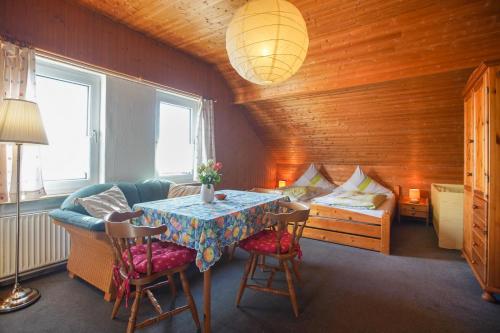 a room with a table and a couch and a bed at Haus Wagenknecht in Borkum
