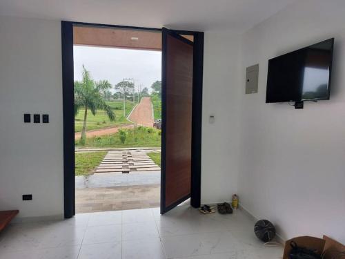 an open door to a room with a view of a yard at Casa de Ensueño. Pedro Vicente Maldonado. in Pedro Vicente Maldonado
