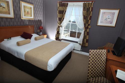 a bedroom with a large bed and a window at Bannatyne Hotel Darlington in Darlington