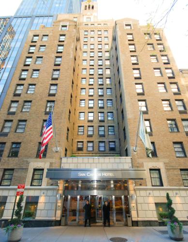 a tall building with people standing in front of it at San Carlos Hotel New York in New York