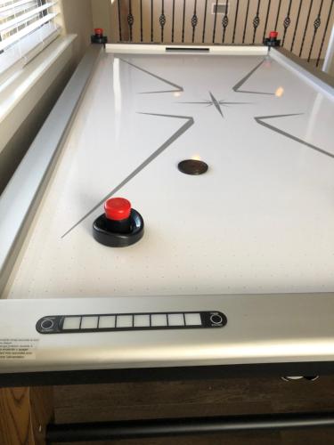 a ping pong table with a red ball on it at The Retreat at Hempstead in Hempstead