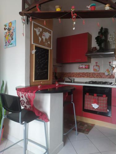 a kitchen with red cabinets and a red counter top at Nido delle meraviglie in Canelli