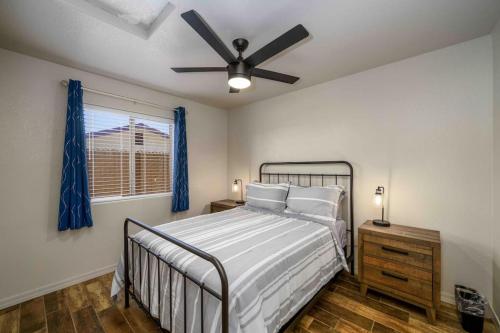 a bedroom with a bed and a ceiling fan at Havasu lake house 4 BR & 3 BA w/pool & hot tub in Lake Havasu City