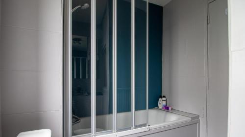 a bathroom with a shower stall with a mirror at London Bridge 3 Bedroom House with reception room, office and private garden in London