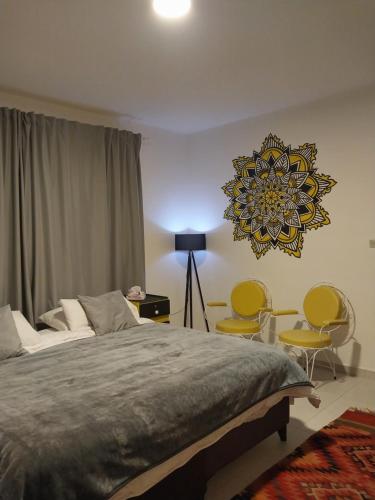 a bedroom with a bed and a chandelier at COCO Guesthouse in Madaba