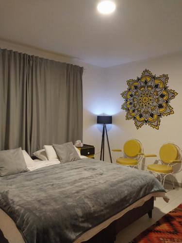 a bedroom with a large bed and two chairs at COCO Guesthouse in Madaba