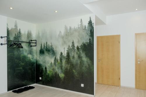 a wall with a painting of a forest at HAMA Design Homes Lippstadt in Lippstadt