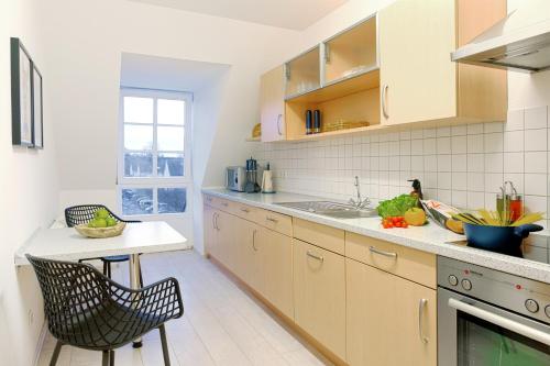 a kitchen with a counter and a sink and a table at HAMA Design Homes Lippstadt in Lippstadt