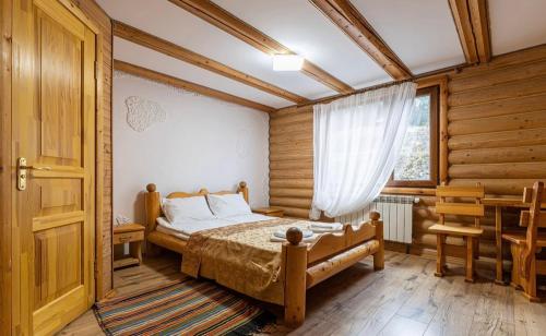 a bedroom with a bed and a window at ВІДЕНЬ in Slavske