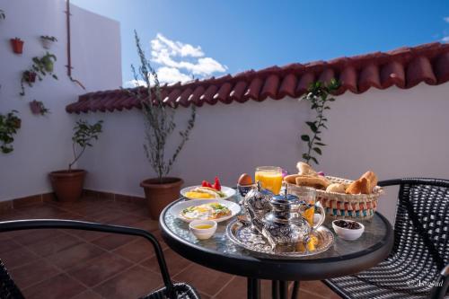 a table with a tray of food on a balcony at Riad Bin Souaki in Chefchaouene