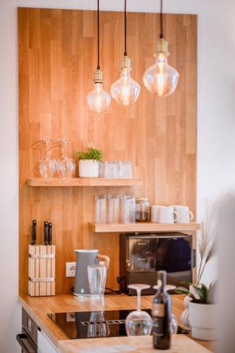 a kitchen with a counter with several lights above it at Da Alois - Alpine Premium Apartments in Gröbming