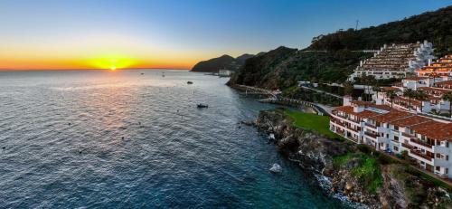 an aerial view of a town on a hill next to the ocean at Premium Ocean Corner Unit, Fireplace, Golf Cart, 21 Steps from Top in Avalon