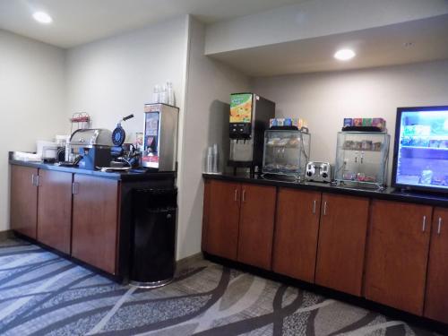a room with two arcade machines and a television at Cobblestone Hotel & Suites - Seward in Seward