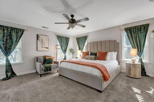 a bedroom with a bed and a ceiling fan at Modern 3-bedroom home with patio and fire pit in Memphis