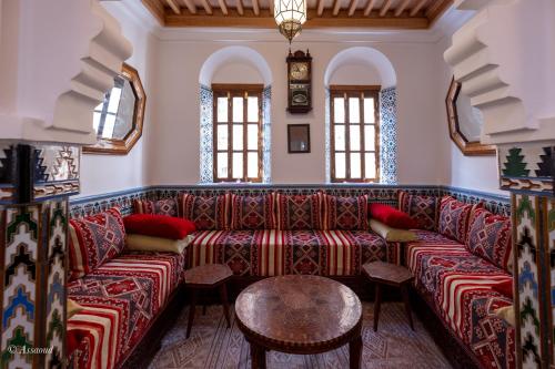 a living room with a couch and a table at Riad Bin Souaki in Chefchaouene