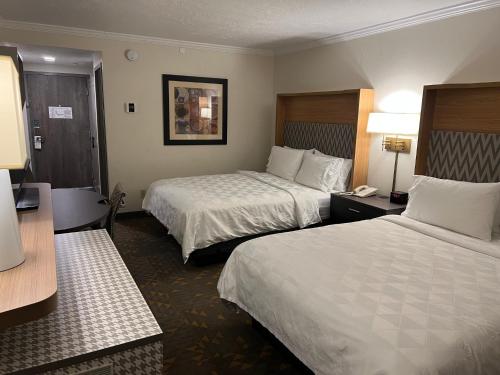 a hotel room with two beds and a telephone at Holiday Inn Rock Springs by IHG in Rock Springs