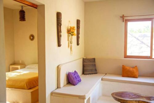 a bedroom with a bed and a window at Casa Lunada in Holbox Island