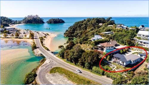 an aerial view of a house next to the ocean at Luxury in Kaiteriteri in Kaiteriteri