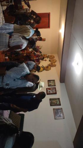 a group of people in a room with pictures on the floor at Nectepec in Cuetzalán del Progreso