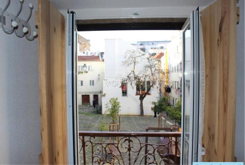 an open door to a balcony with a view of a courtyard at Casa Da Severa Apartments in Lisbon