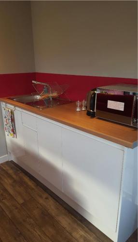 a kitchen counter with a toaster oven on top of it at Wee Shed in Portree