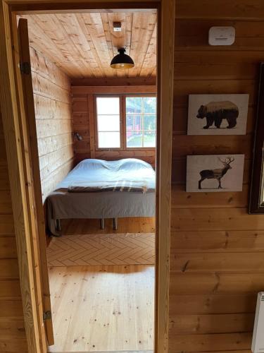 a bedroom in a log cabin with a bed in it at Holiday Home Ruka Lammensyli in Ruka
