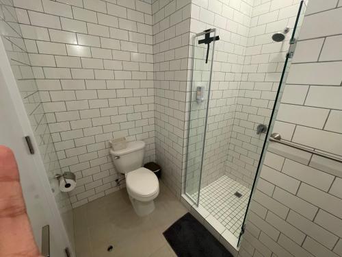 a bathroom with a toilet and a glass shower at 2br aptSurrounded by history with Modern Amenities in Panama City