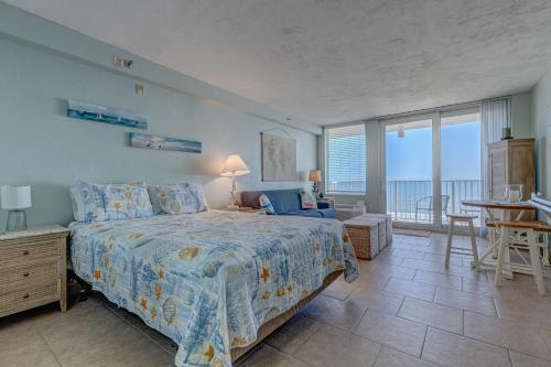 a bedroom with a bed and a room with a balcony at The Ocean Calls, Unit #612 in Daytona Beach
