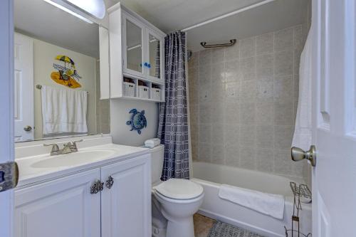a bathroom with a toilet and a sink and a shower at The Ocean Calls, Unit #612 in Daytona Beach