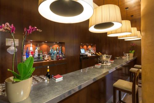 a bar in a hotel room with a long counter at NH Collection Palacio de Burgos in Burgos