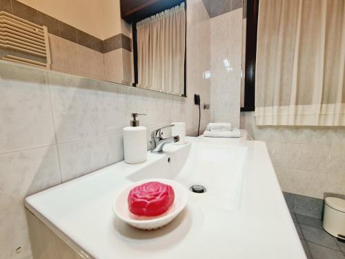 a bathroom with a sink with a red bowl on it at San Siro House in Milan