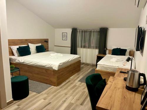 a hotel room with two beds and a table at Prenociste kod Brana in Čačak