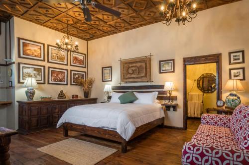 a bedroom with a bed and a chandelier at Residence Las Flores in La Paz