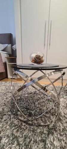 a glass coffee table with a glass top on a rug at Premium Studio Apartment - Belgrade Waterfront in Sajmište