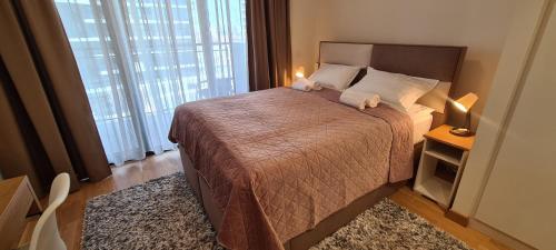 a bedroom with a bed with two stuffed animals on it at Premium Studio Apartment - Belgrade Waterfront in Sajmište