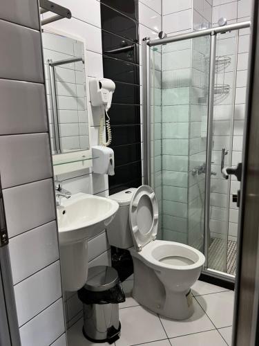 a bathroom with a toilet and a sink and a shower at Deni Apartments in Prilep